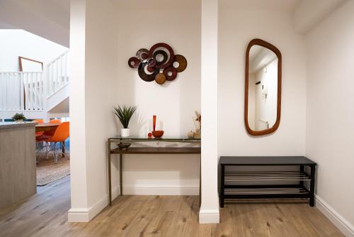 a hallway with a table and a mirror on a wall at The Amazing Triplex - City Centre - Free Parking in Sheffield