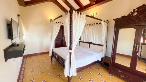 a bedroom with two beds and a television in it at The Royale Ridge in Kotagiri