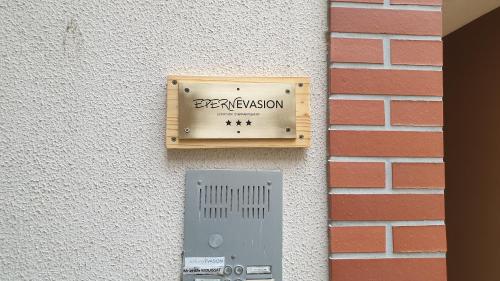 a metal box on the side of a brick wall at Epernevasion in Épernay