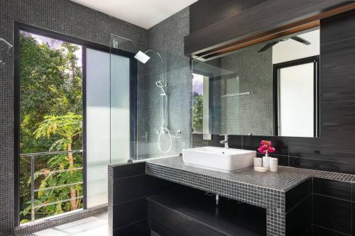 a bathroom with a sink and a mirror at Monkey Villa Chaweng Noi koh samui in Koh Samui 