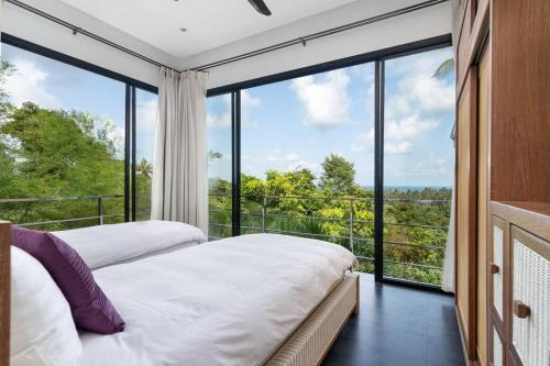 two beds in a room with a large window at Monkey Villa Chaweng Noi koh samui in Koh Samui 