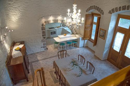 a kitchen and dining room with a table and chairs at Mansion Eugenie in Hydra