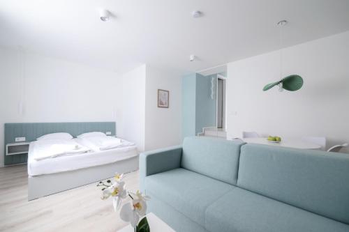 a living room with a couch and a bed at Villa Oliver 2 Hévíz in Hévíz