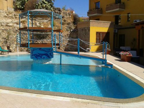 una grande piscina con scivolo d'acqua di HOTEL LE PALME a SantʼAnna Arresi