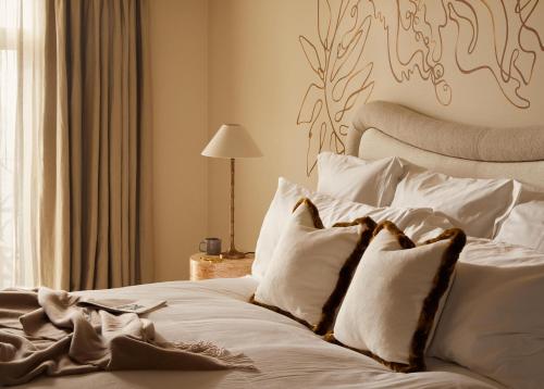 a bedroom with a bed with white sheets and pillows at No 42 by GuestHouse, Margate in Margate