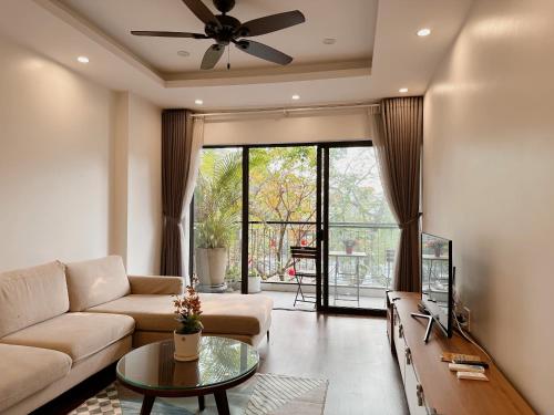 a living room with a couch and a table at Luxe Paradise Residence Trinh Cong Son in Hanoi