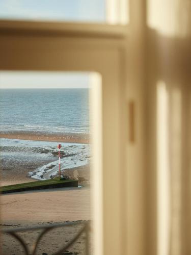 a view of a beach from a window at No 42 by GuestHouse, Margate in Margate