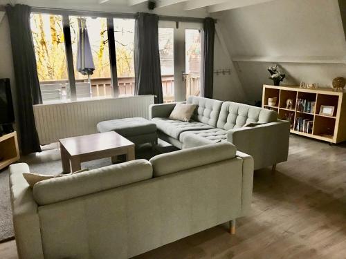 a living room with two couches and a table at Chalet 46 Casa Fantasia in Durbuy