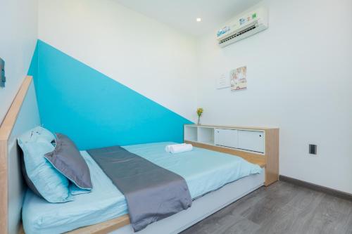 a bedroom with a bed with a blue canopy at Sea House Hotels and Apartments in Vung Tau