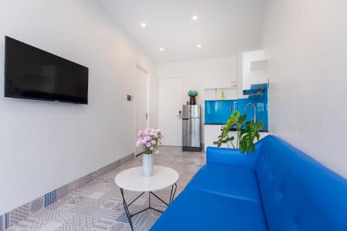 a living room with a blue couch and a table at Sea House Hotels and Apartments in Vung Tau