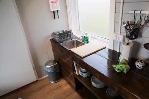 a kitchen with a sink and a wooden counter top at Áshamrar in Hella