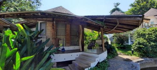 a small house with a large wooden roof at Koh Mak Cococape Resort in Ko Mak