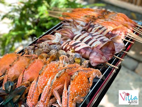 a bunch of different types of seafood on a grill at Villa by the Win Pattaya in Jomtien Beach