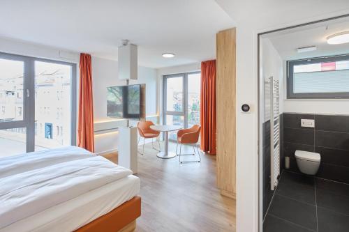 a bedroom with a bed and a table with chairs at VR-Serviced Apartments Gerstungen in Gerstungen