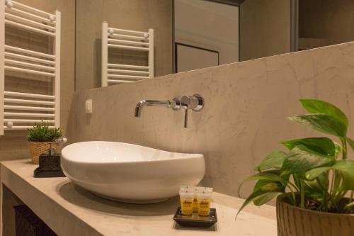 a bathroom with a white bowl sink on a counter at Luxury Apt with Parking-Living Stone Silver in Athens
