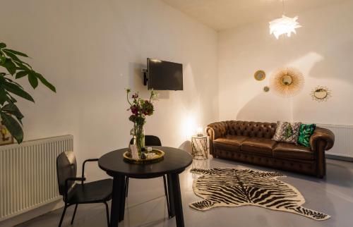 a living room with a couch and a table at Hotel Zilt Studio's in Vlissingen