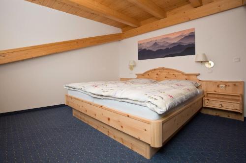 a bedroom with a wooden bed in a room at Gästehaus Lödermann in Garmisch-Partenkirchen