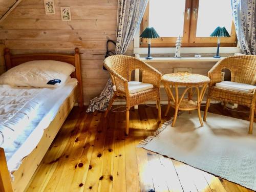 a bedroom with a bed and chairs and a table at Meerhaus in Zingst