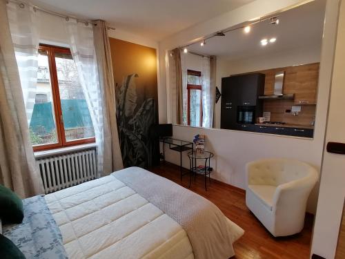 a bedroom with a bed and a chair in it at CASA VACANZA IL SORRISO DEL LAGO in Avigliana