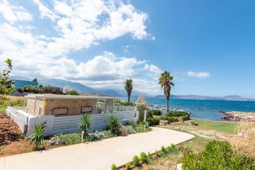 a house with a view of the ocean at Artemis Seafront Stone Studio in Petres