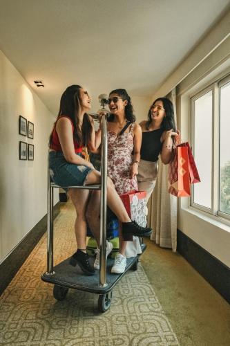 a group of three women standing in a room at Grand Mercure Bangalore - An Accor Brand in Bengaluru