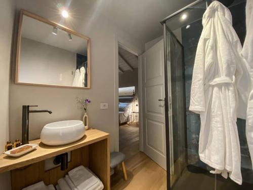 a bathroom with a shower and a sink and a mirror at La torre in Belgirate