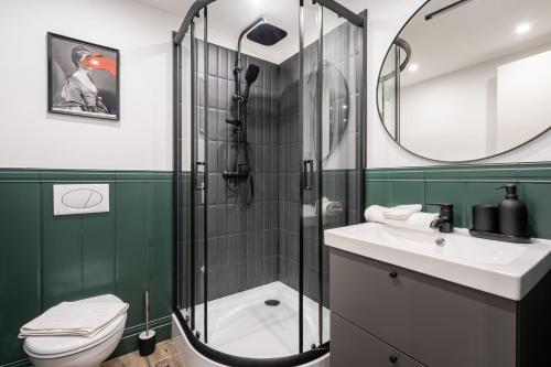 a bathroom with a shower and a toilet and a sink at E41- Boutique Apartments, Best Location, by BQA in Budapest