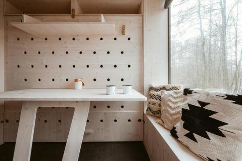 a tiny house with a table and a window at Posed Za humny in Arnolec