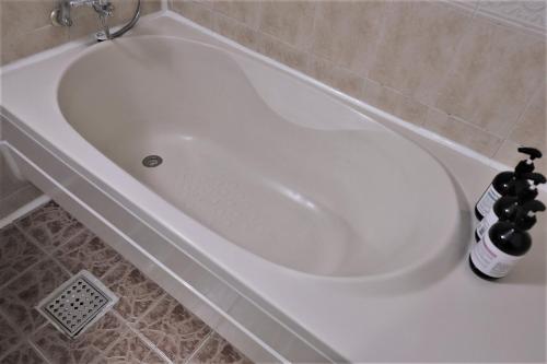 a white bath tub in a bathroom at Hani Motel in Daejeon