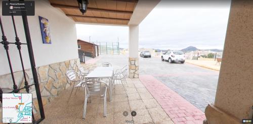 a patio with a table and chairs on the side of a building at Finca La Ecarada. Férez (Albacete) in Férez