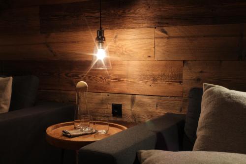 a room with a couch and a table with glasses on it at Chalet Tannenhof in Lermoos