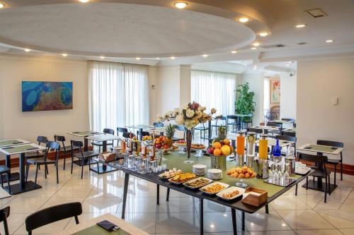 a large room with tables and chairs with food on them at Best Western Hotel Viterbo in Viterbo