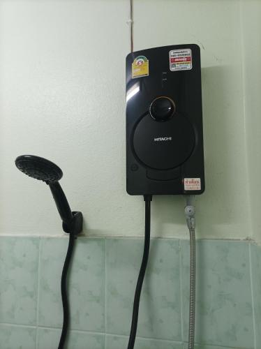 a blow dryer is attached to a wall at Jatuporn A1 in Pathum Thani