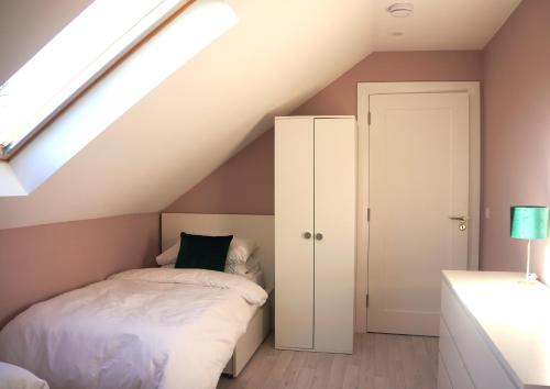 a attic bedroom with a bed and a skylight at Àit Sèan Òg - 2bedroom self catering apartment 