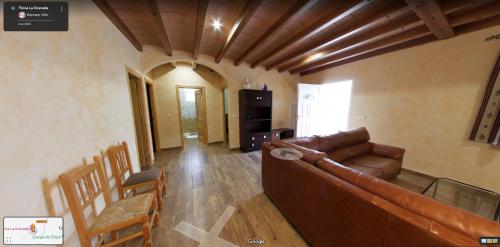a living room with a couch and a table and chairs at Finca La Ecarada. Férez (Albacete) in Férez