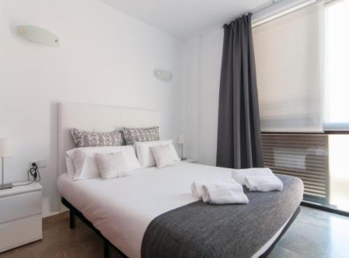 a bedroom with a large white bed with white pillows at Picasso Suites in Barcelona