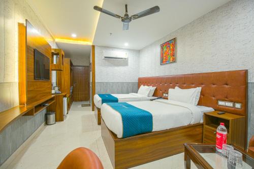 a hotel room with two beds and a table at RONTA WORLD HOTELS in Chandīgarh