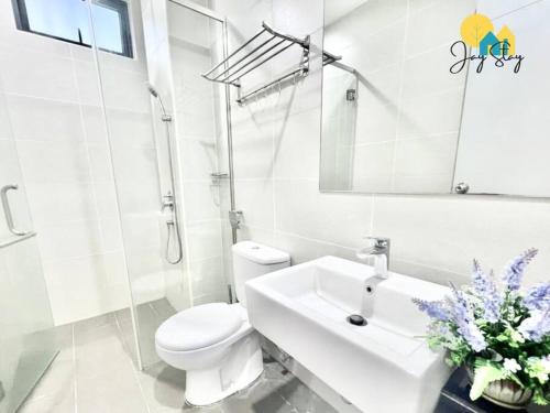 a white bathroom with a toilet and a sink at NEW! Atlantis Residence I D1607 Premium 2BR I 5-10pax I Swing I JonkerSt I City Centre by Jay Stay in Melaka