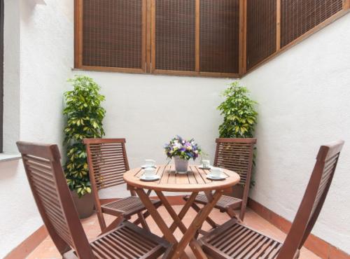 a wooden table and chairs on a patio at Picasso Suites in Barcelona