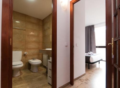 a bathroom with a toilet and a sink at Picasso Suites in Barcelona