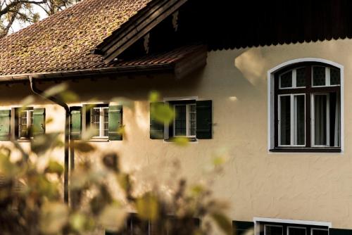 a white house with windows and a roof at Blyb Hotel in Gmund am Tegernsee