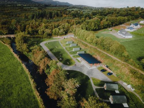 an aerial view of a farm with a building and trees at Comeragh Pods in Kilmacthomas