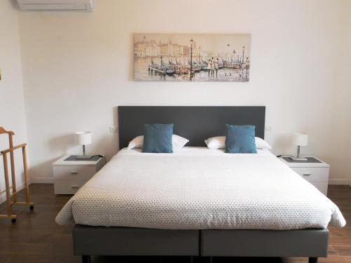 a bedroom with a large bed with blue pillows at VCE House in Tessera