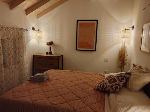 a bedroom with a bed and a dresser and lights at Garitsa Apartments B in Agios Rokkos