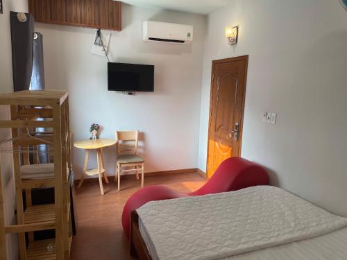 a bedroom with a bed and a table with a chair at Phú Gia Hotel 1609 in Ho Chi Minh City