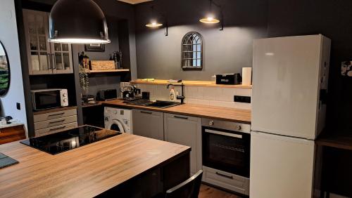 a kitchen with a white refrigerator and a wooden counter top at Apartamento Aguilera in Gandía