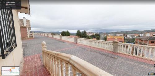 a balcony with a white railing on a building at Finca La Ecarada. Férez (Albacete) in Férez