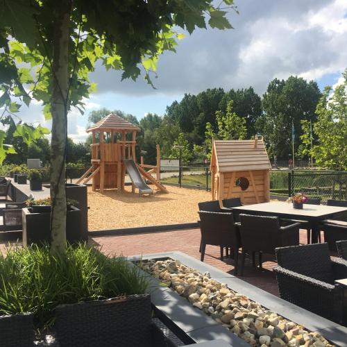 a park with a playground with a table and a play structure at Van der Valk Cuijk - Nijmegen in Nijmegen