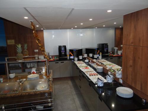 a kitchen with a bunch of food on the counters at Hotel Relax in Słubice