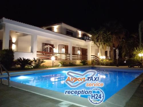 a house with a swimming pool at night at Villa Modus Vivendi in Cinisi